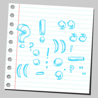 various punctuation marks including a colon written in blue pen on a piece of notebook paper